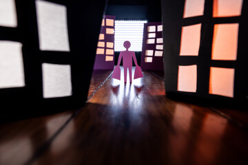 Conceptual image of a man holding shopping bags standing alone in an urban alley surrounded by...