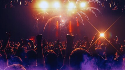 Celebratory fireworks illuminate the night sky over a vibrant city park, a spectacular light show for the dancing crowd at a festive concert