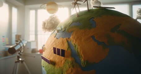Modern STEM Classroom: Close Up of Rotating Earth Model with Miniature 3D Models of Wind Turbines...