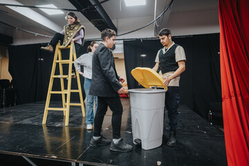 A group of young actors performing a play rehearsal on stage, featuring dynamic interactions,...