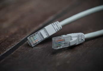 ethernet internet cat6 lan white cable close up shot on dark theme background 