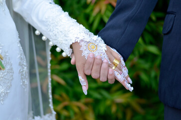 bride and groom holding hands