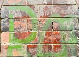 Old building brick structure with scribbled bricks.