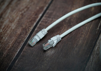 ethernet internet cat6 lan white cable close up shot on dark theme background 