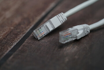 ethernet internet cat6 lan white cable close up shot on dark theme background 