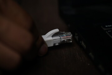 ethernet internet cat6 lan white cable close up shot on dark theme background 