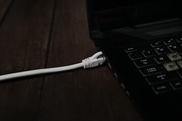 ethernet internet cat6 lan white cable close up shot on dark theme background 