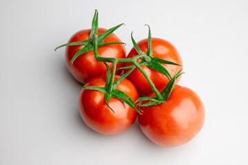 Fresh ripe tomatoes on vine isolated on white background