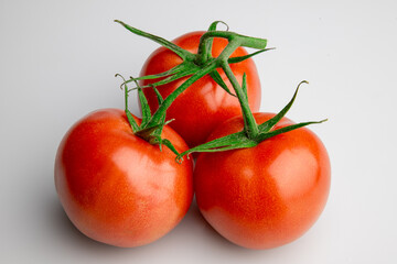 Fresh ripe tomatoes on vine isolated on white background