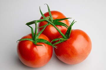 Fresh ripe tomatoes on vine isolated on white background