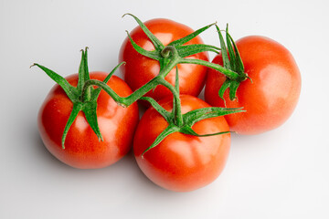 Fresh ripe tomatoes on vine isolated on white background