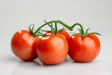 Fresh ripe tomatoes on vine isolated on white background