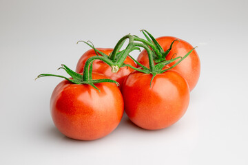 Fresh ripe tomatoes on vine isolated on white background