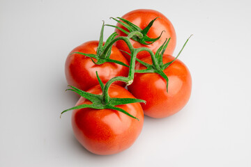 Fresh ripe tomatoes on vine isolated on white background