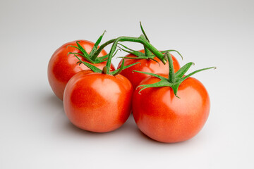 Fresh ripe tomatoes on vine isolated on white background