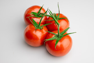 Fresh ripe tomatoes on vine isolated on white background