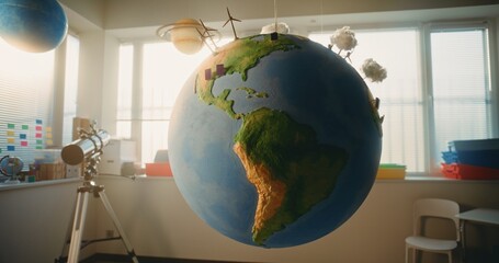 Globe with Miniature 3D Models of Wind Turbines and Solar Panels Hanging in Modern Classroom. Earth...