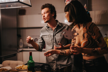 A lively indoor birthday celebration with friends engaged in conversation, enjoying snacks and drinks, creating a joyful and festive atmosphere.