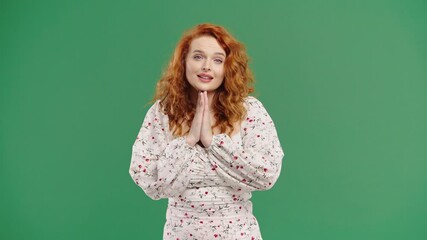 Ginger-haired woman praying with palms in sincere silent request. Hope, faith