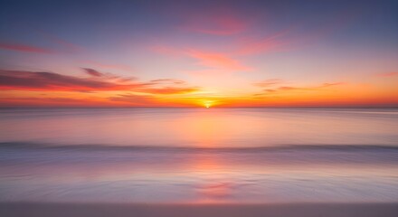 Obraz premium Serene seascape view featuring a vibrant sunrise over the tranquil ocean horizon with colorful reflections in the water.