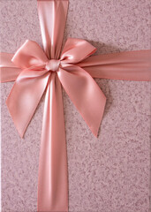 Elegant gift with soft pink bow close-up shot from above