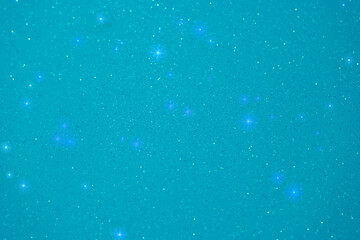 Night sky filled with sparkling stars against a turquoise background creates a serene and mystical atmosphere