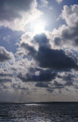 The sun peeks through the clouds and the sea, Spanish coastline