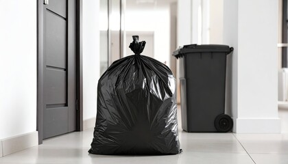 Full black garbage bag on floor