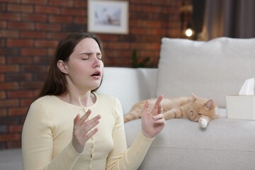 Woman suffering from allergy with her cat at home
