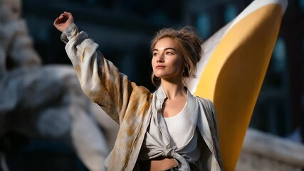 A performer engaging an audience with a flag in a city square