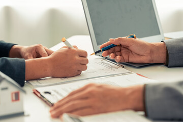 The real estate agent discussed the terms of the home purchase contract and asked the client to...