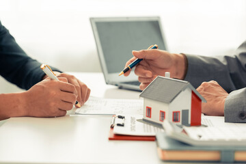 The real estate agent discussed the terms of the home purchase contract and asked the client to...