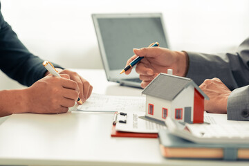 The real estate agent discussed the terms of the home purchase contract and asked the client to...