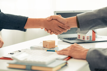 Real estate businessman shaking hands with client after business meeting to start contract for...