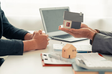 The real estate agent discussed the terms of the home purchase contract and asked the client to...