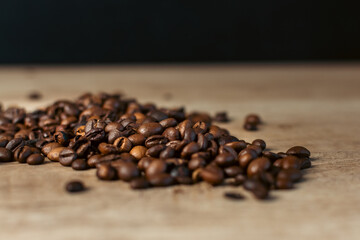 Roasted coffee beans on rustic wooden table