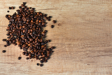 Roasted coffee beans on rustic wooden table