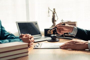 A group of lawyers and business people meet in an office. A team of business lawyers work together...