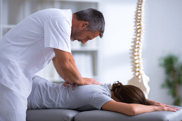 Chiropractor Adjusts Patient's Spine. Doctor performs spinal manipulation for back pain relief. Health concept. Use for marketing, healthcare, and web.