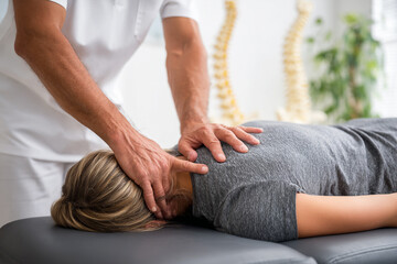 Chiropractor adjusts patient's neck in clinic. Shows health, wellness, and medical concepts. For marketing, advertising, web design.