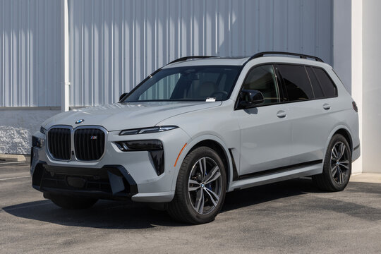 BMW X7 M60i luxury SUV display at a dealership. BMW offers the X7 with a 4.4L Turbocharged Hybrid V8 engine. MY:2026