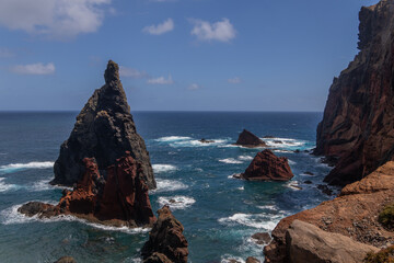Pinnacle rock between cliffs in Atlantic waters. Madeira