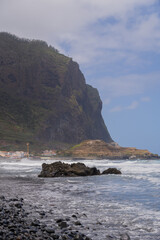 Rocky beach and massive cliff Vertical