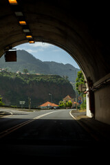 Fototapeta premium Tunnel exit view of coastal mountain road. Madeira