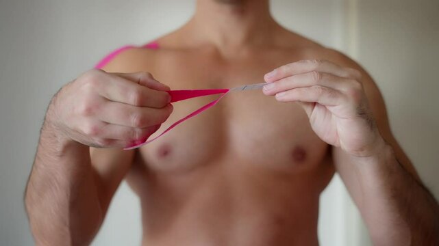 A detailed closeup image of kinesiology tape applied on a shoulder during the process of rehabilitation. Using Kinesiology Tape on the Shoulder for Effective Injury Recovery and Rehabilitation