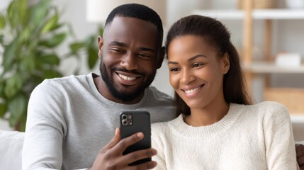 Happy couple watching smartphone at home, smiling and relaxing together