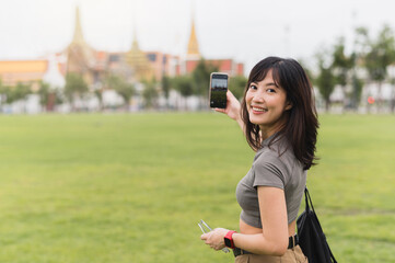 Happy southeast asian woman teenager blogger on solo world travel. An explorer local cultural...