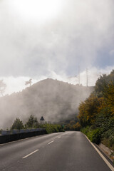 Misty mountain road and cloudy sky Vertical