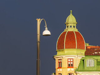 Lamppost stands beside historic building under dark sky in Gothenburg showing architectural details