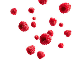 Red raspberries falling in the air against a black background.